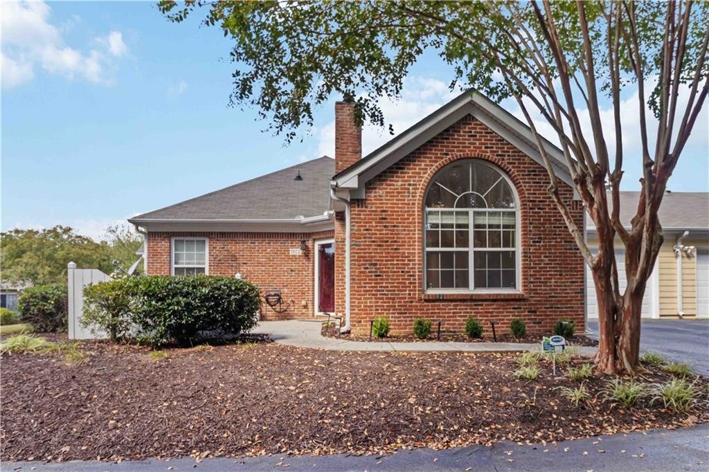 2191 Rockbridge Road Southwest, Unit 1602 Stone Mountain, GA 30087 - Photo 1 of 1 a front view of a house with garden