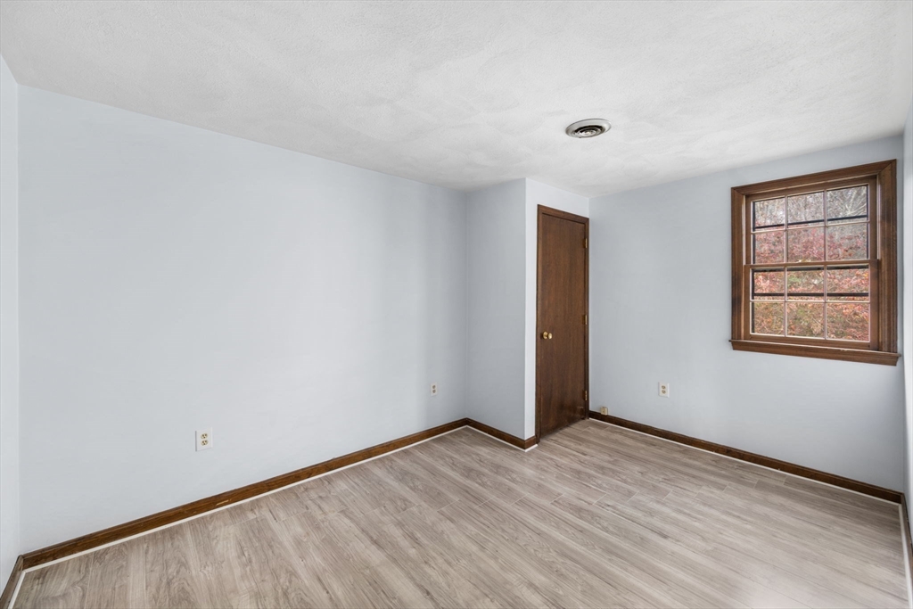 17 Blackstone Road Billerica, MA 01862 - Photo 11 of 32 a view of an empty room with wooden floor and a window