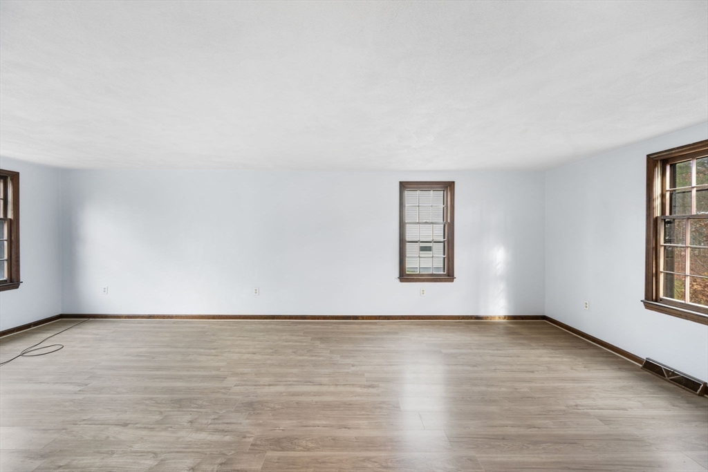 17 Blackstone Road Billerica, MA 01862 - Photo 15 of 32 an empty room with wooden floor and windows