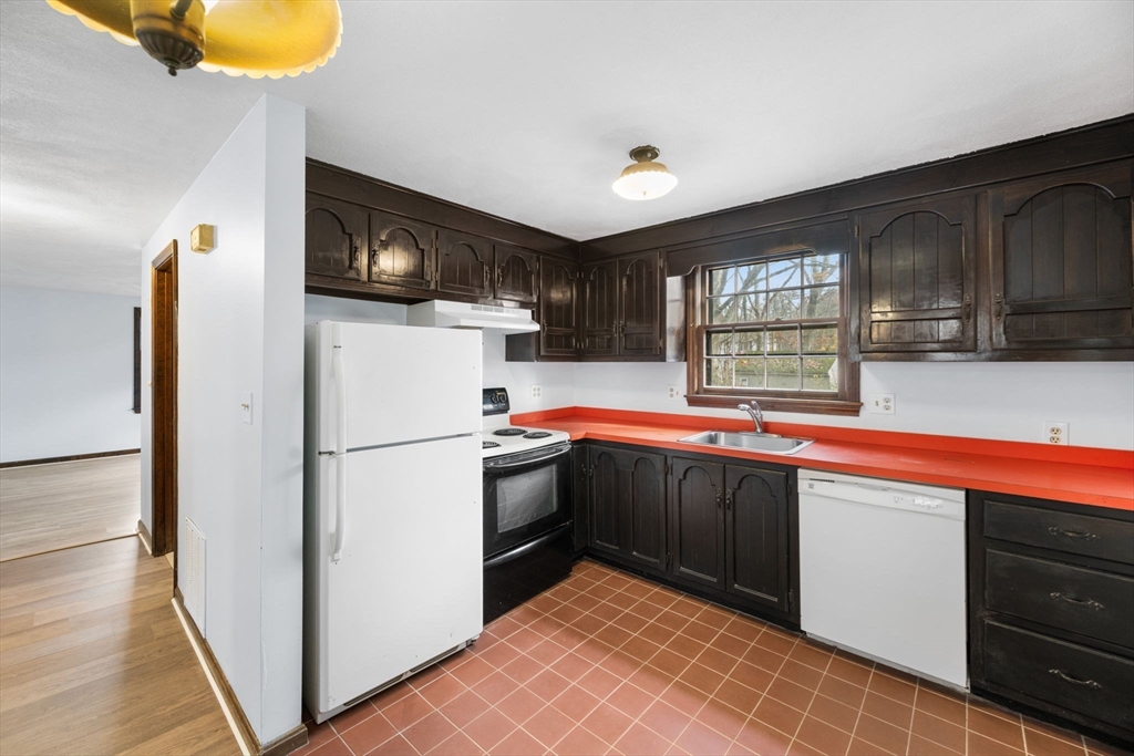 17 Blackstone Road Billerica, MA 01862 - Photo 21 of 32 a kitchen with a refrigerator and a sink