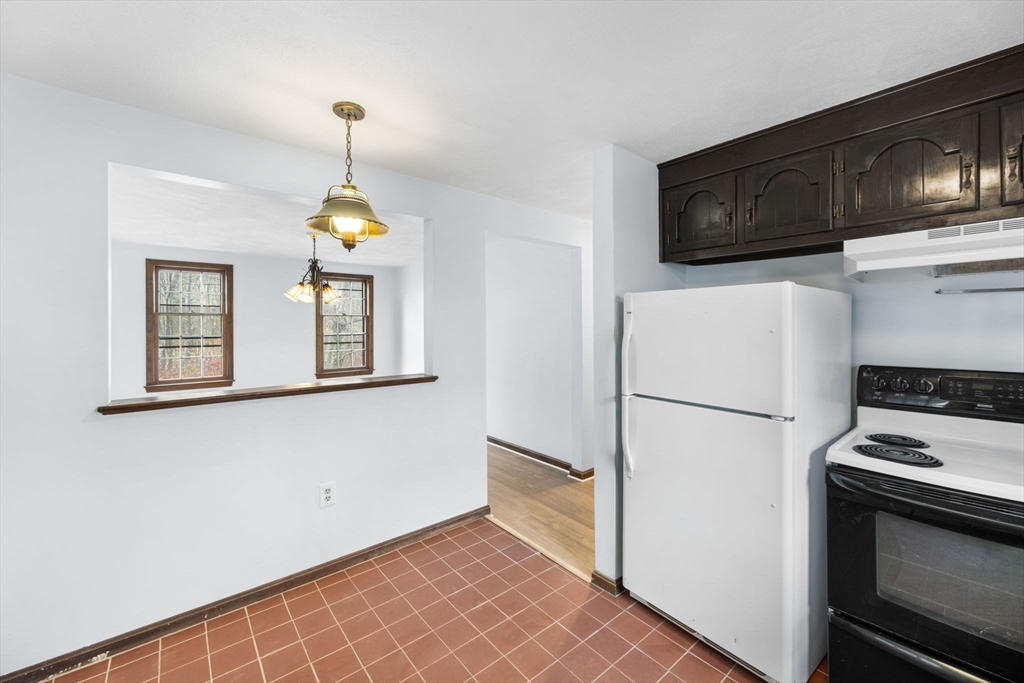 17 Blackstone Road Billerica, MA 01862 - Photo 22 of 32 a kitchen with a refrigerator a stove a microwave and cabinets