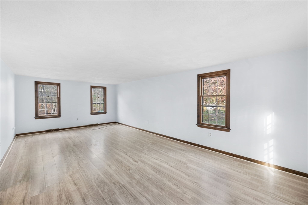17 Blackstone Road Billerica, MA 01862 - Photo 5 of 32 an empty room with wooden floor and windows