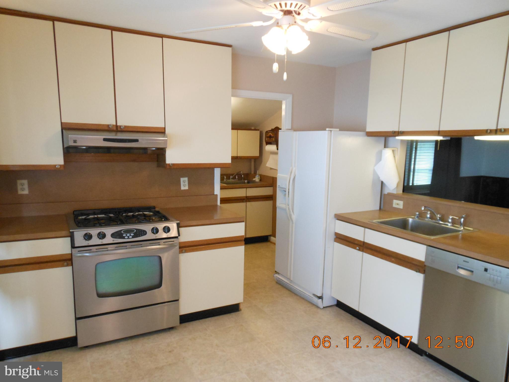 3704 Holly Grove Road Baltimore, MD 21220 - Photo 2 of 13 a kitchen with a stove and a refrigerator