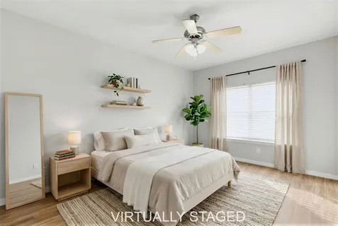 a bedroom with a large bed and a chandelier