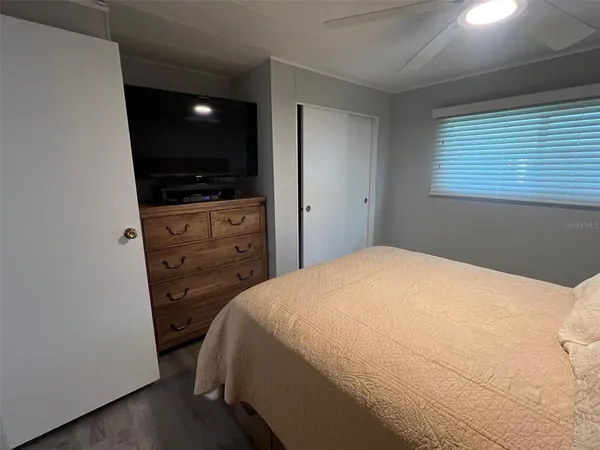 a bedroom with a bed and a flat screen tv