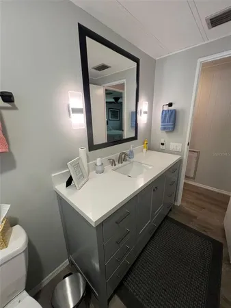 a spacious bathroom with a double vanity sink and a mirror
