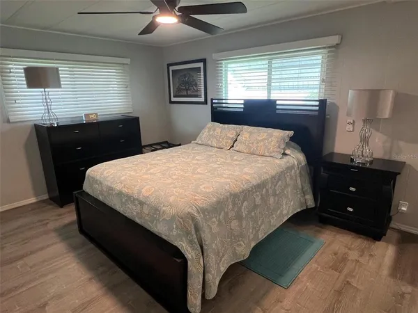 a bed sitting in a bedroom next to a window