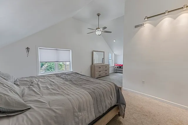 a bed room with a bed mirror and a ceiling fan
