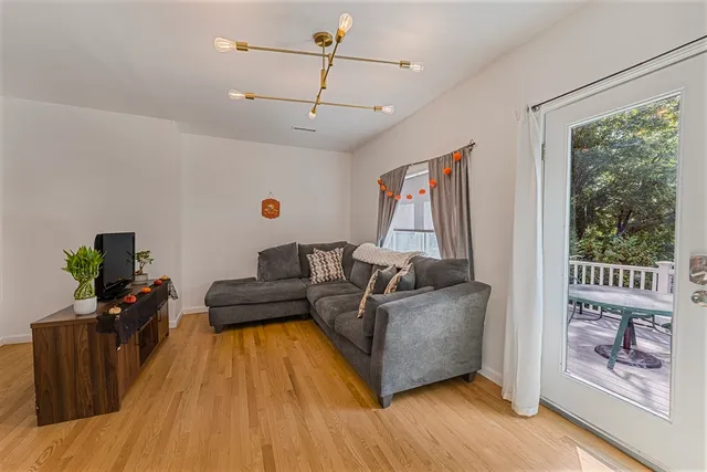 a living room with furniture and wooden floor