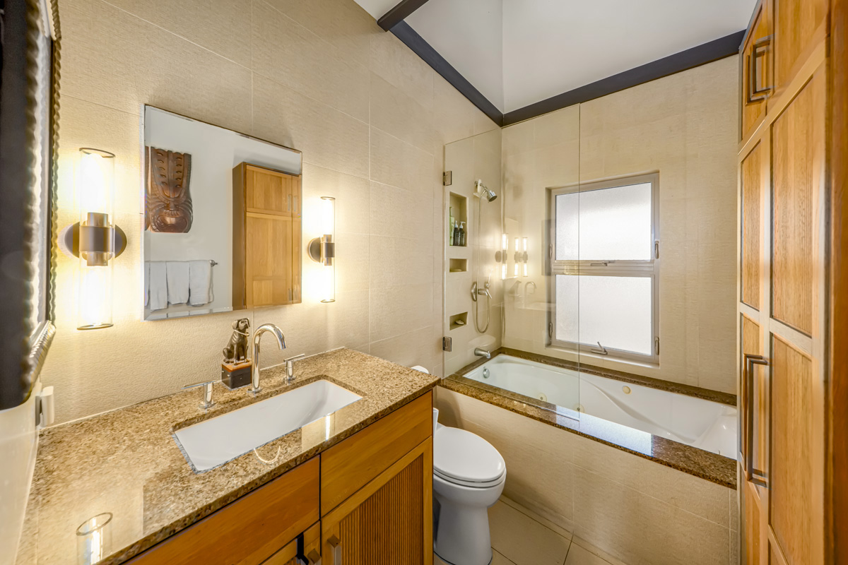 12-7124 Kalapana Kapoho Beach Road Pahoa, HI 96778 - Photo 14 of 30 a bathroom with a granite countertop sink mirror vanity and a bathtub