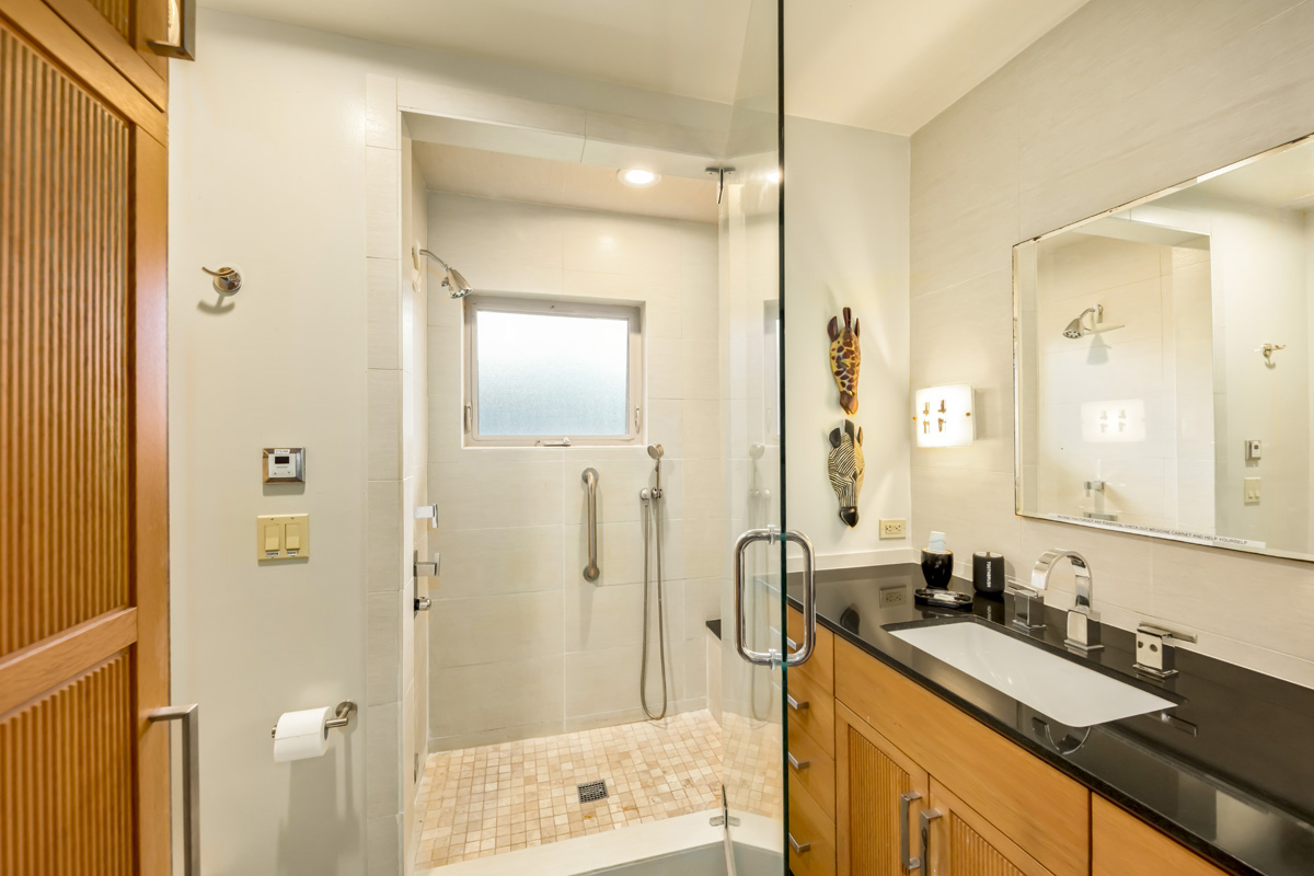 12-7124 Kalapana Kapoho Beach Road Pahoa, HI 96778 - Photo 18 of 30 a bathroom with a sink a mirror a bathtub and shower