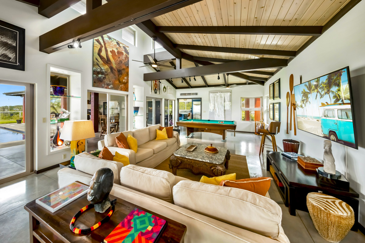 12-7124 Kalapana Kapoho Beach Road Pahoa, HI 96778 - Photo 8 of 30 a living room with furniture a rug and a chandelier