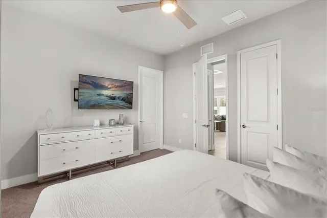 a room with a bed and a flat tv screen in it