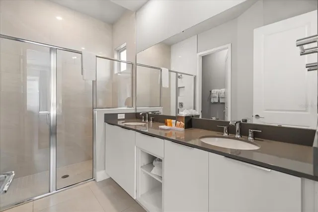a bathroom with double sink and a mirror