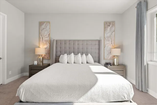 a large white bed in a white room