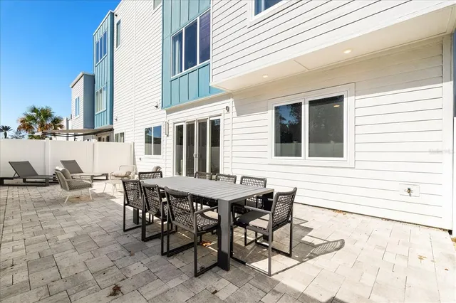 a view of a dinning table and chairs in the patio