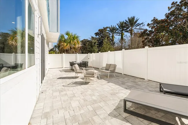 a view of a patio with a table and chairs and potted plants