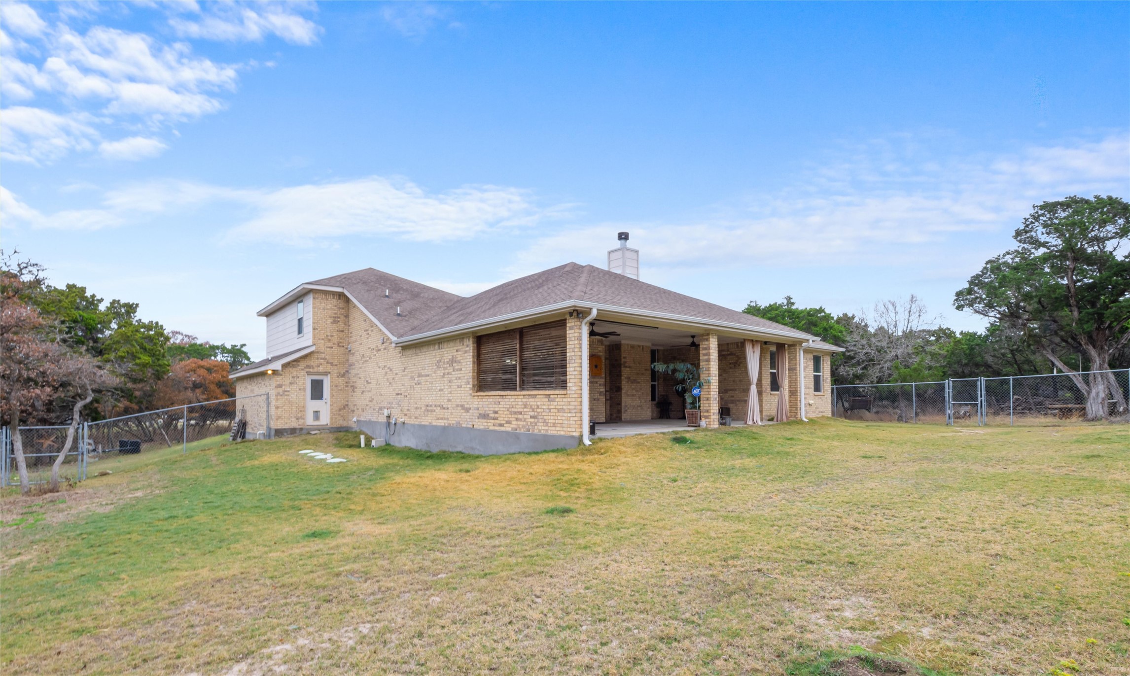 16017 Toby Court Temple, TX 76502 - Photo 26 of 33 Back of house with a fenced backyard, ceiling fan, a patio area, a chimney, and brick siding