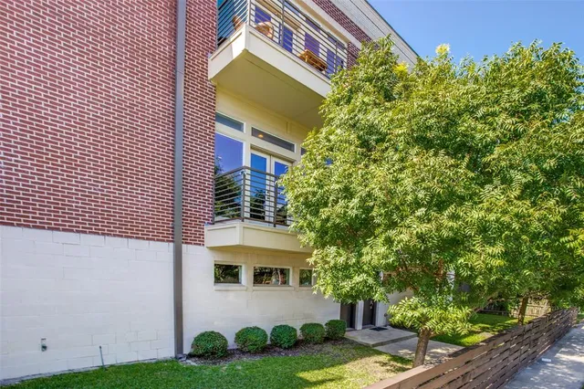 a front view of a house with a tree