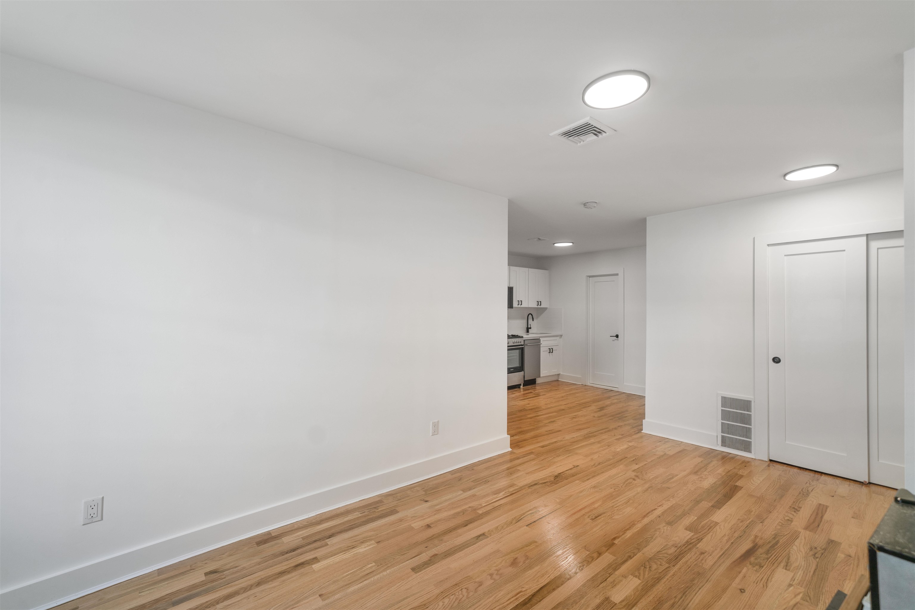 163 3rd Street, Unit 1A Hoboken, NJ 07030 - Photo 3 of 12 a view of an empty room and wooden floor
