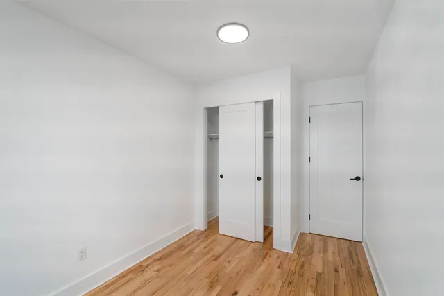 a view of a room with wooden floor