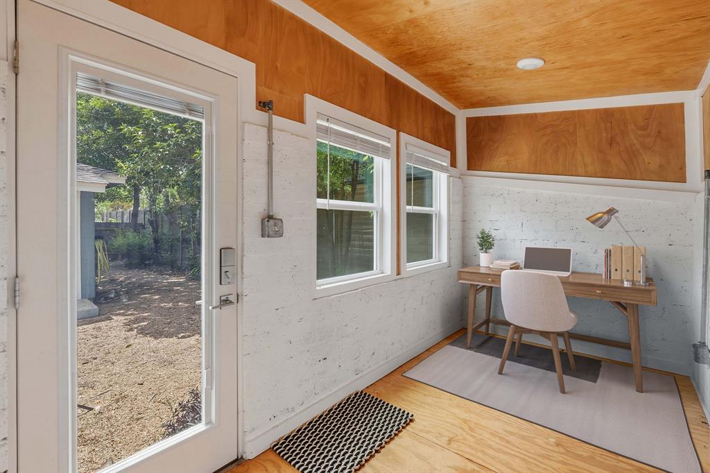 900 Stark Street Austin, TX 78756 - Photo 21 of 25 A versatile office space features warm wood paneling and abundant natural light for an inspiring work environment.