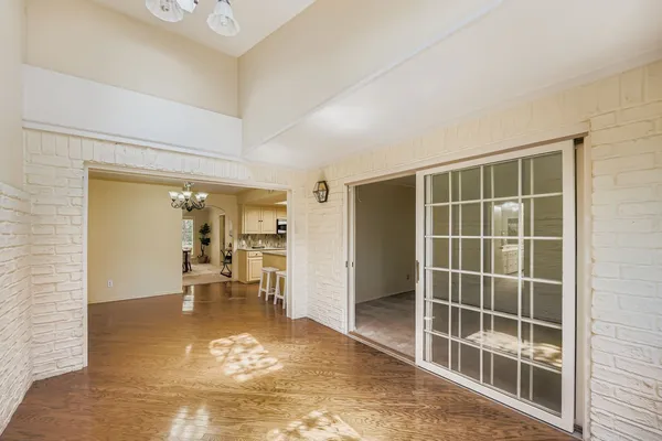 a view of a livingroom with wooden floor and a large window