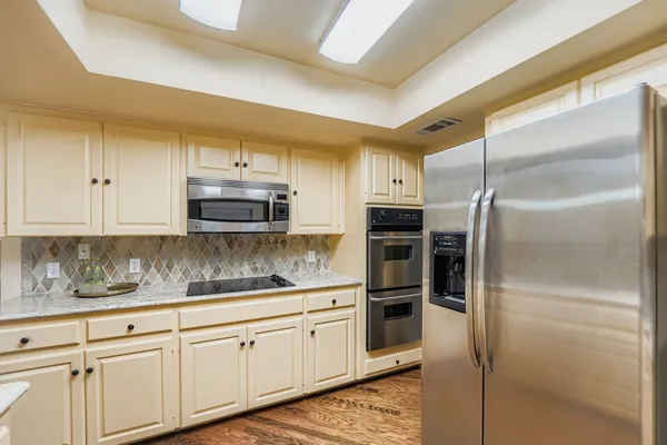 a kitchen with a refrigerator and cabinets
