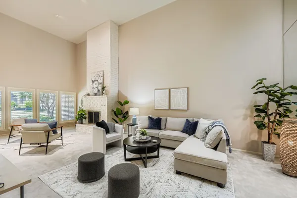 a living room with furniture potted plant and a large window