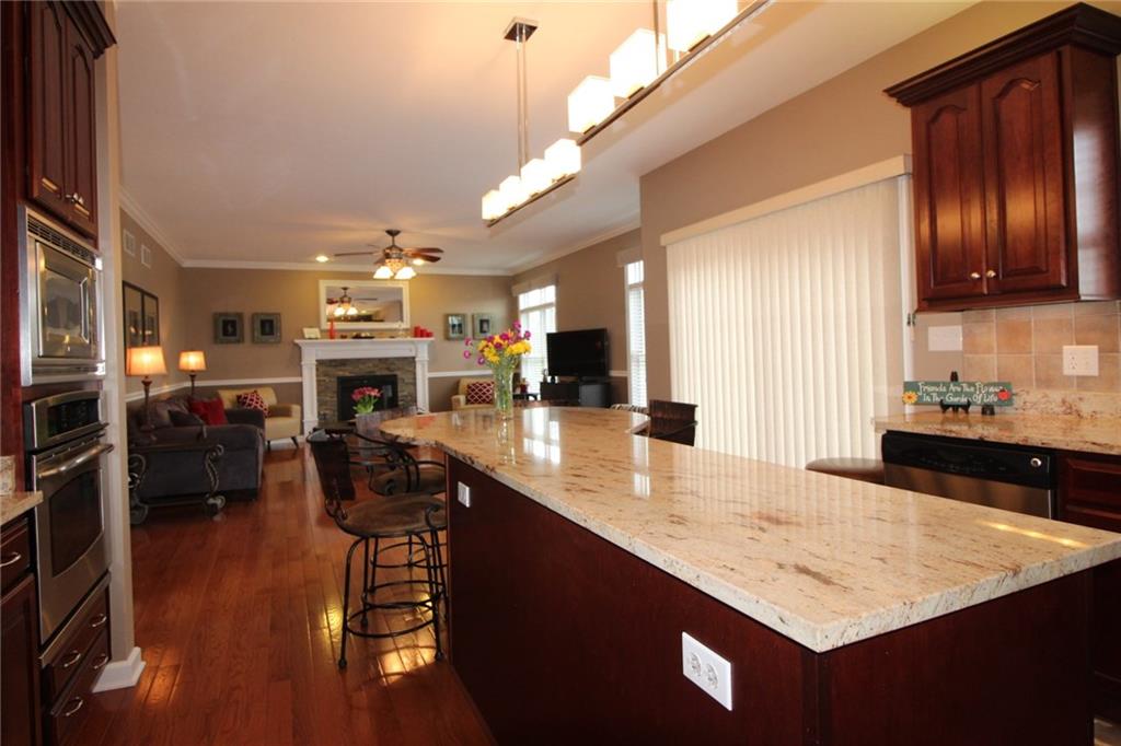 106 Rochelle Lane Monaca, PA 15061 - Photo 8 of 25 Kitchen looking into family room. Note that there are several convenient outlets on the granite island. The gorgeous cabinets are cherry.