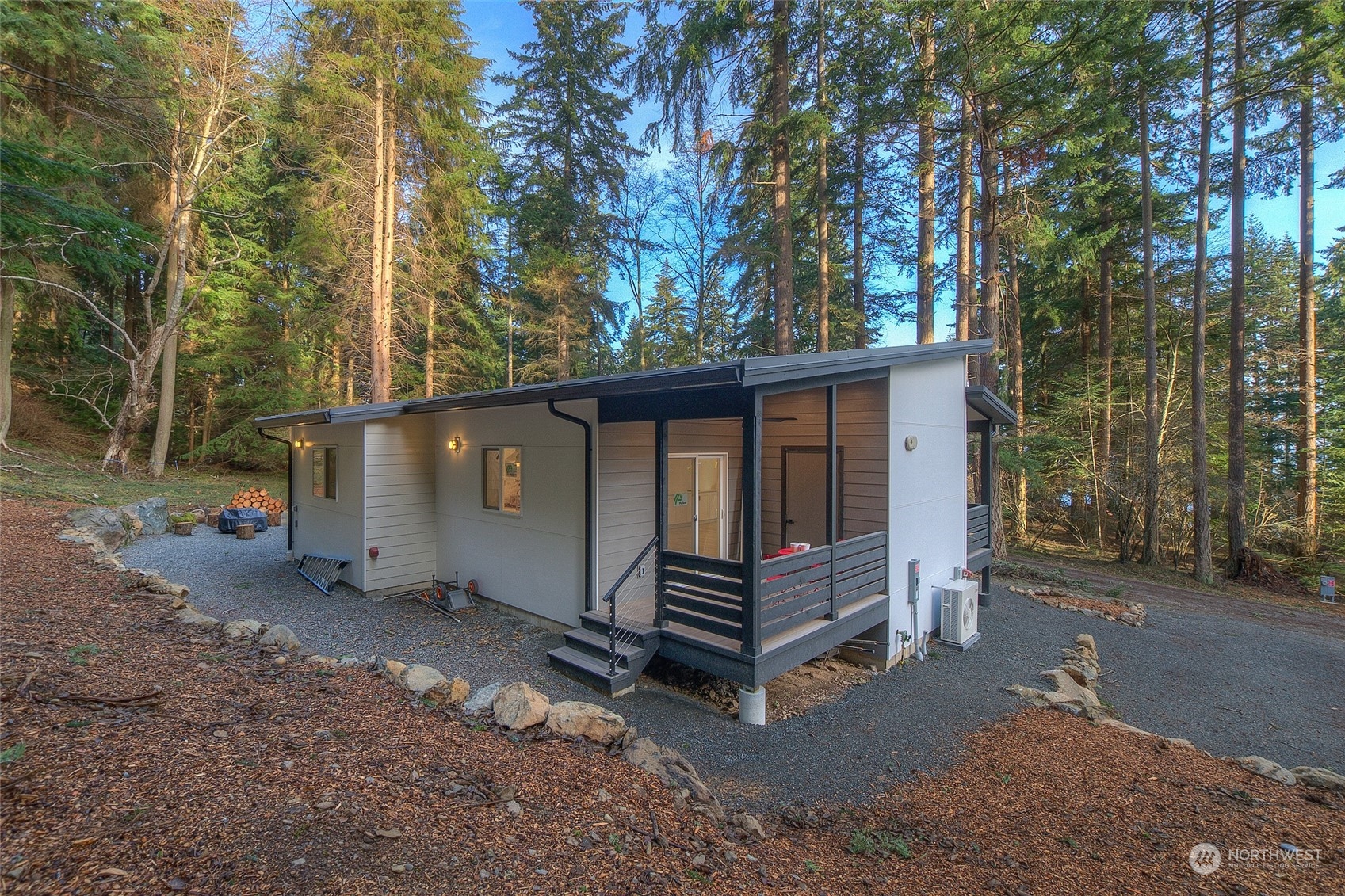 2567 Raccoon Point Road Orcas Island, WA 98245 - Photo 1 of 40 a view of wooden house with a large trees and wooden fence