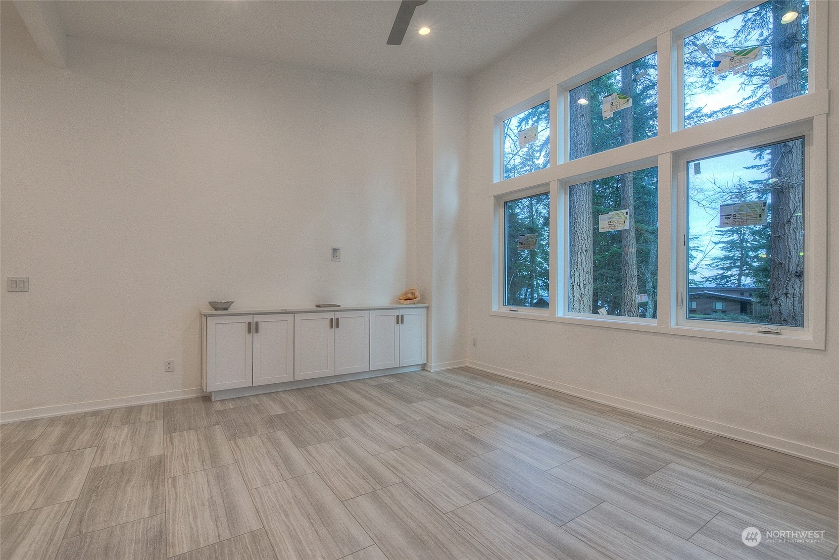 2567 Raccoon Point Road Orcas Island, WA 98245 - Photo 18 of 40 an empty room with wooden floor and windows