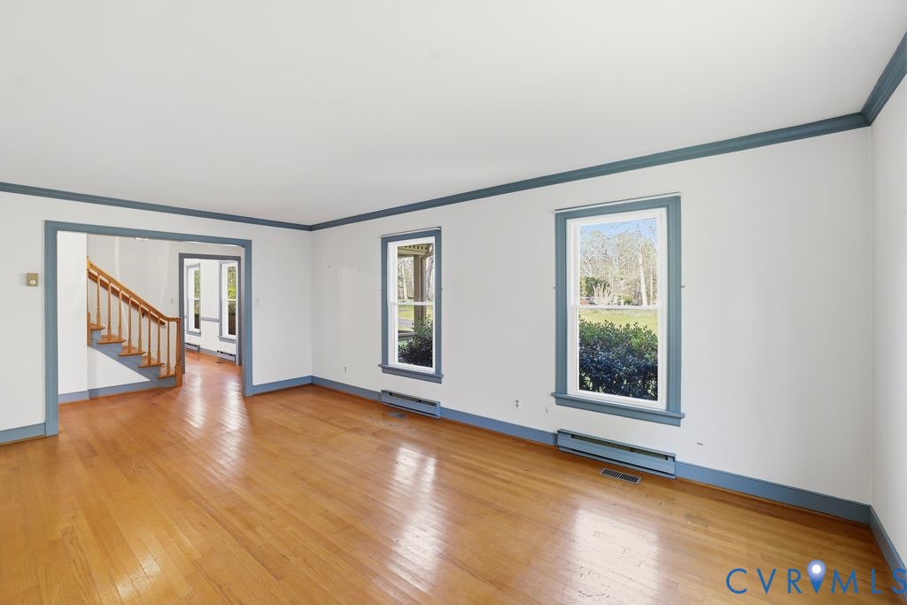 11352 Rockville Road Rockville, VA 23146 - Photo 16 of 38 a view of an empty room with wooden floor and a window