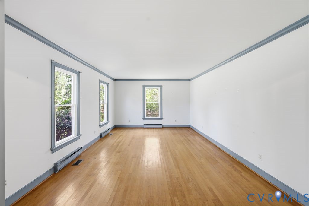11352 Rockville Road Rockville, VA 23146 - Photo 17 of 38 an empty room with wooden floor and windows