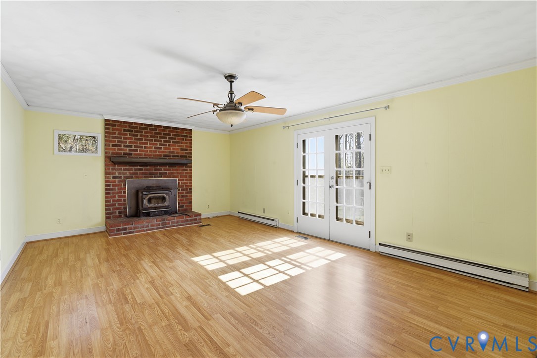 11352 Rockville Road Rockville, VA 23146 - Photo 18 of 38 a view of empty room with wooden floor and fireplace