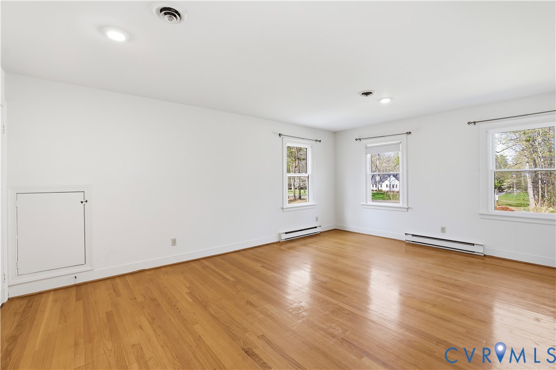 11352 Rockville Road Rockville, VA 23146 - Photo 23 of 38 an empty room with wooden floor and windows