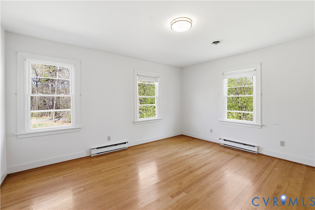 11352 Rockville Road Rockville, VA 23146 - Photo 27 of 38 an empty room with wooden floor and windows