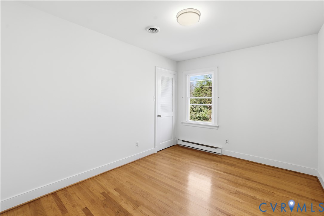 11352 Rockville Road Rockville, VA 23146 - Photo 30 of 38 an empty room with wooden floor and windows