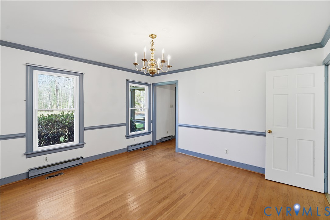 11352 Rockville Road Rockville, VA 23146 - Photo 8 of 38 a view of an empty room with a window and wooden floor