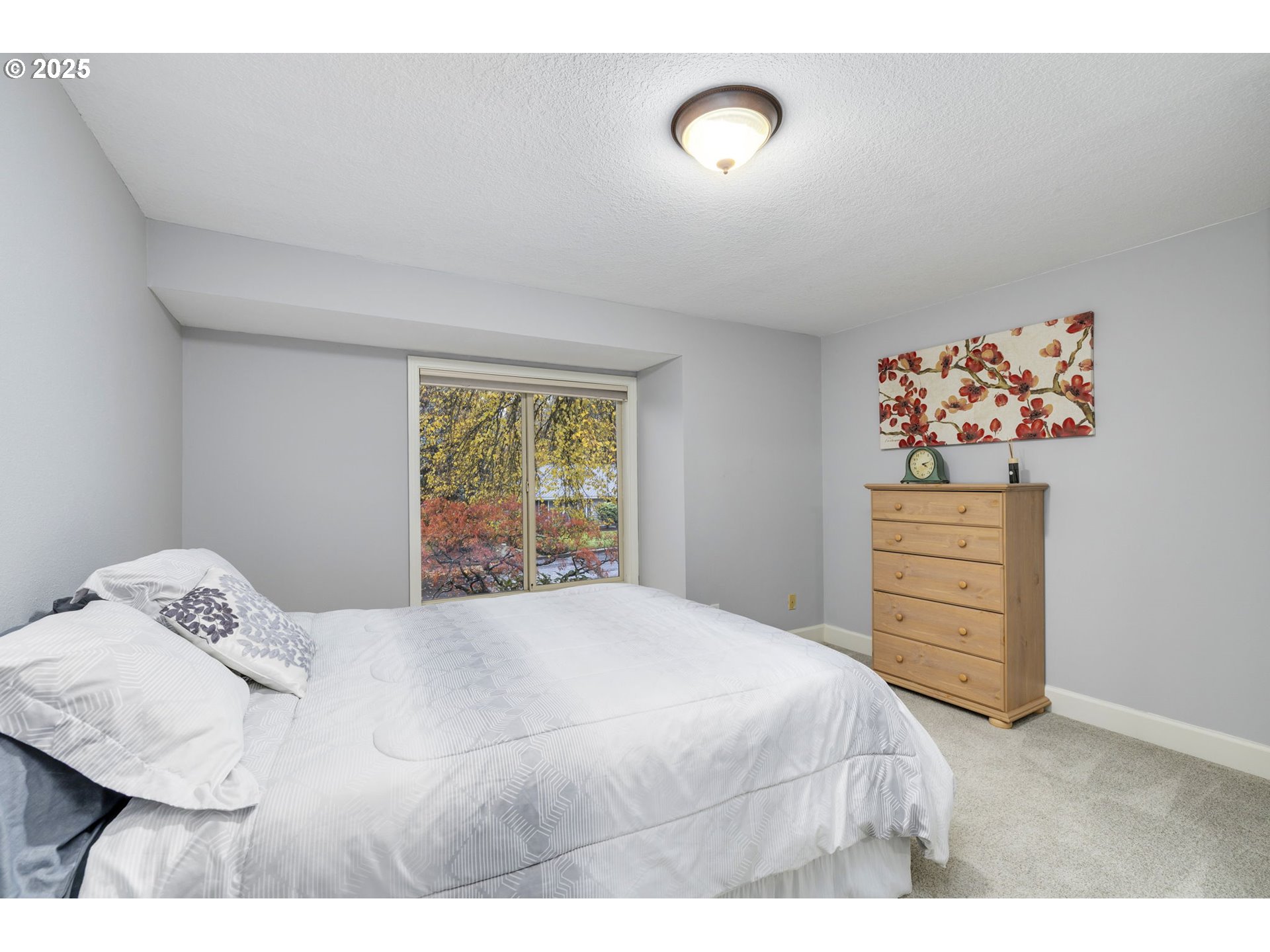 19895 Northwest Nestucca Drive Portland, OR 97229 - Photo 15 of 33 a bedroom with a bed and a cabinets