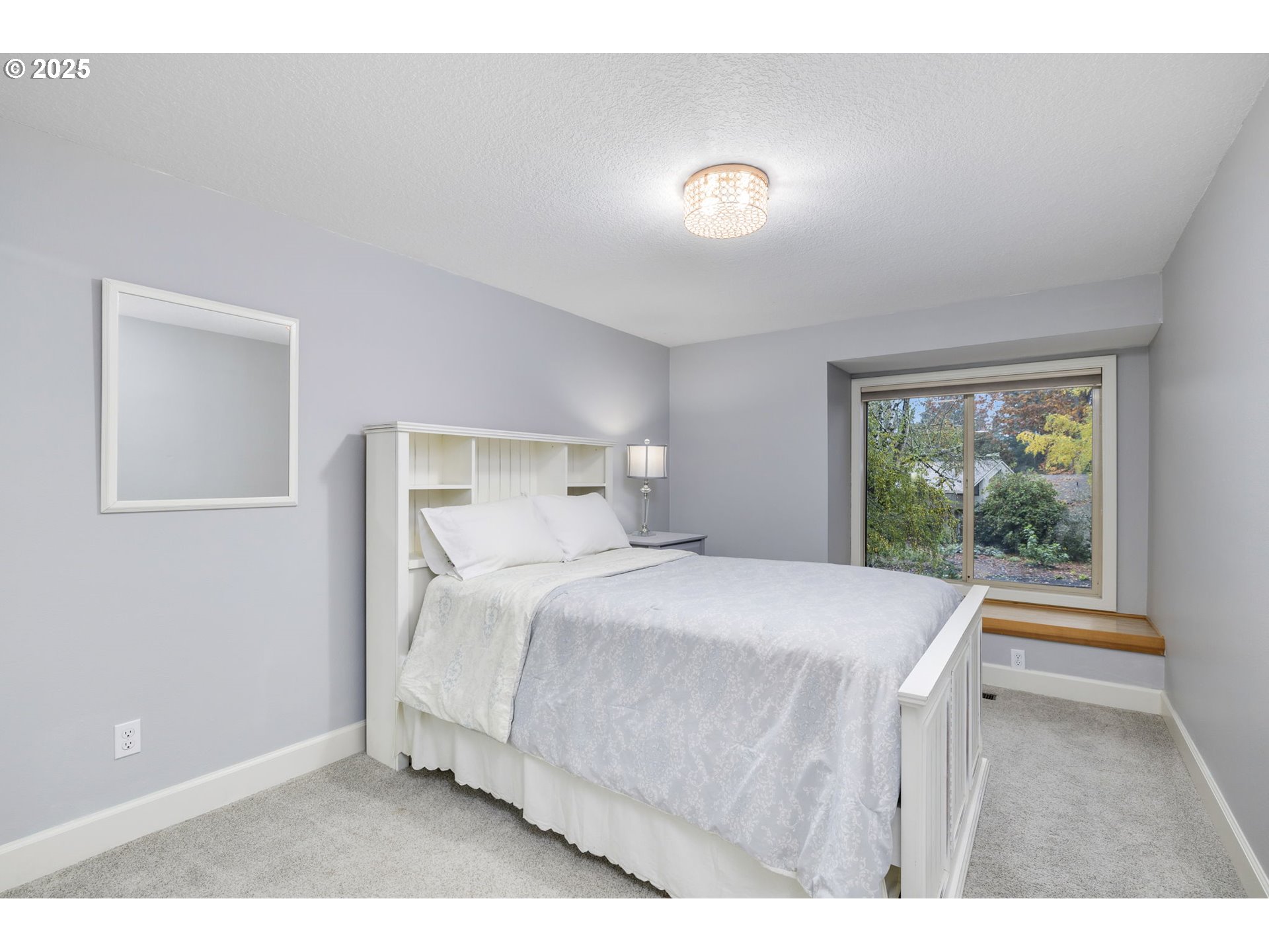 19895 Northwest Nestucca Drive Portland, OR 97229 - Photo 16 of 33 a bedroom with a bed and a large window