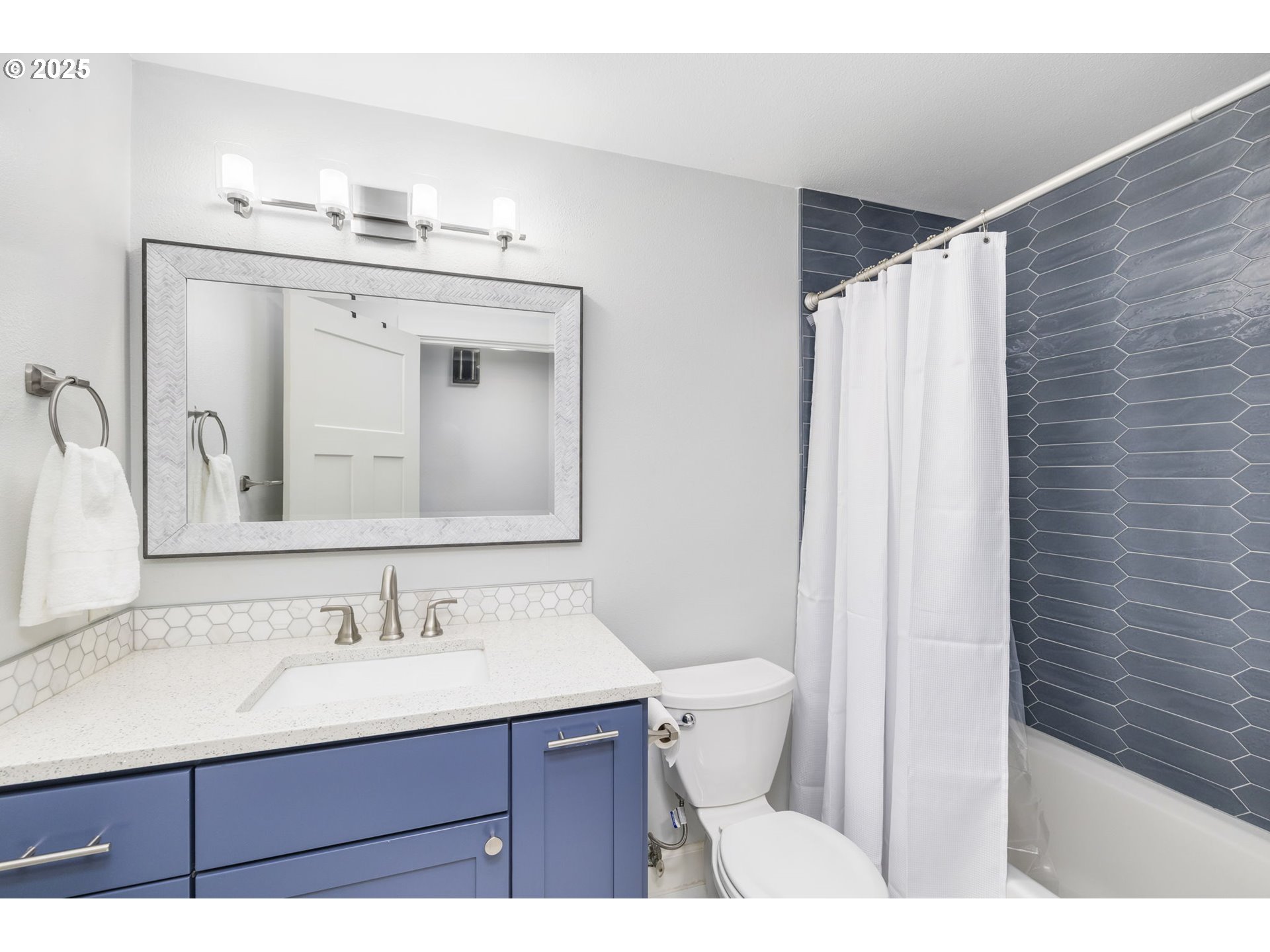 19895 Northwest Nestucca Drive Portland, OR 97229 - Photo 17 of 33 a bathroom with a sink vanity granite toilet and a mirror