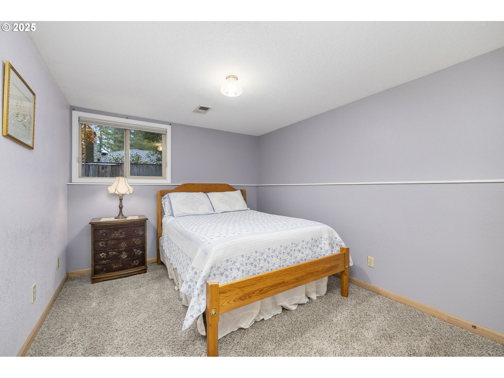 19895 Northwest Nestucca Drive Portland, OR 97229 - Photo 18 of 33 a bedroom with a bed and window