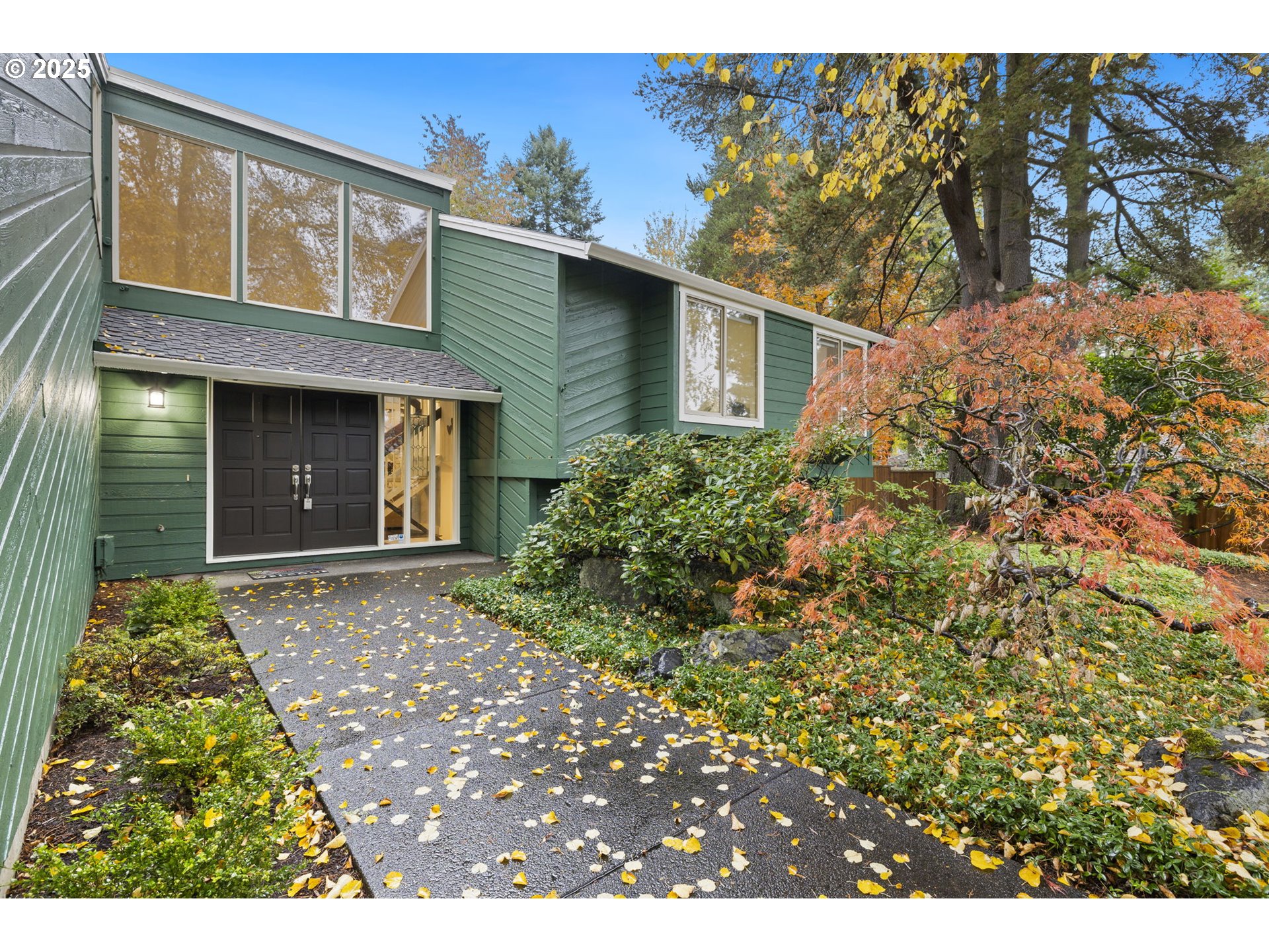 19895 Northwest Nestucca Drive Portland, OR 97229 - Photo 2 of 33 a view of a house with brick walls and a tree