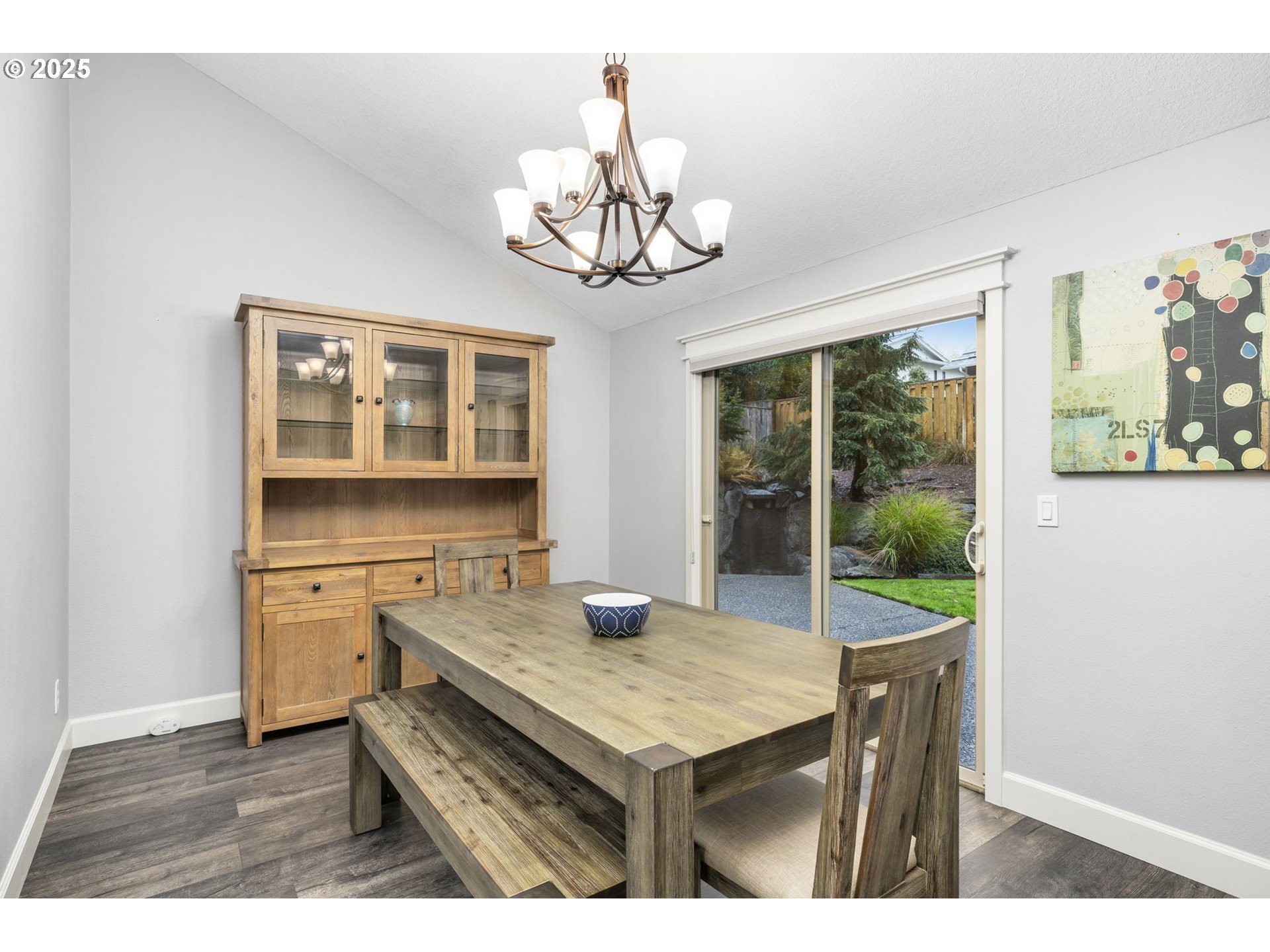 19895 Northwest Nestucca Drive Portland, OR 97229 - Photo 6 of 33 a dining room with wooden floor a chandelier a wooden table and chairs