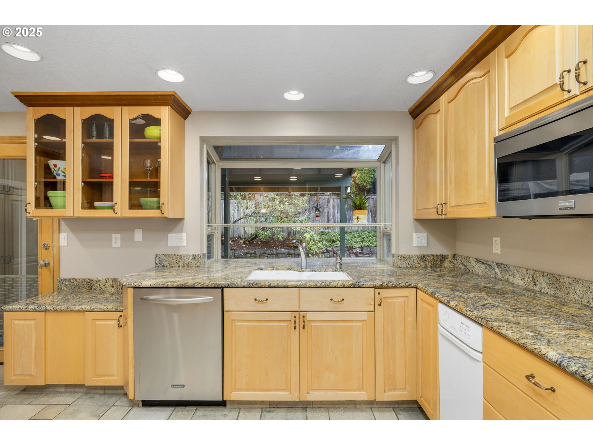 19895 Northwest Nestucca Drive Portland, OR 97229 - Photo 8 of 33 a kitchen with a sink a stove and cabinets