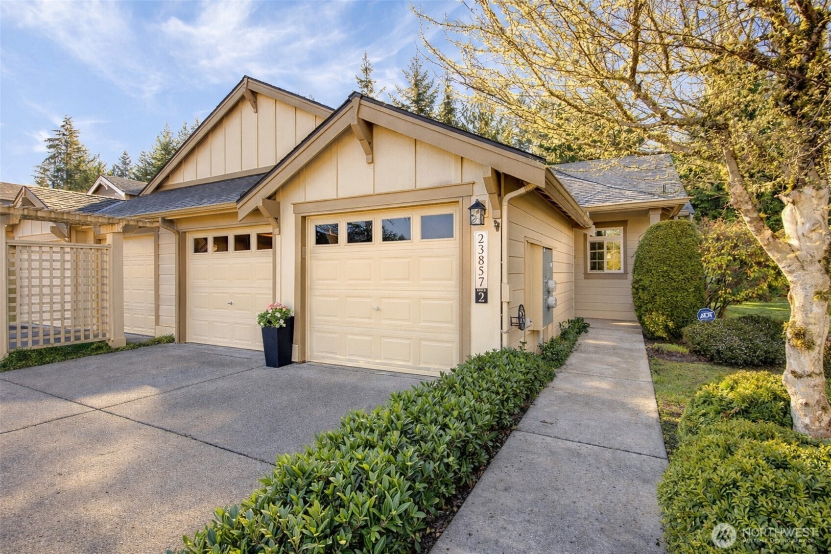 23857 Northeast 112th Circle, Unit 2 Redmond, WA 98053 - Photo 1 of 28 a front view of a house with a yard and garage