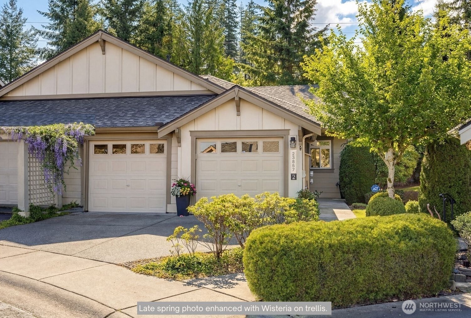 23857 Northeast 112th Circle, Unit 2 Redmond, WA 98053 - Photo 2 of 28 a front view of a house with garden