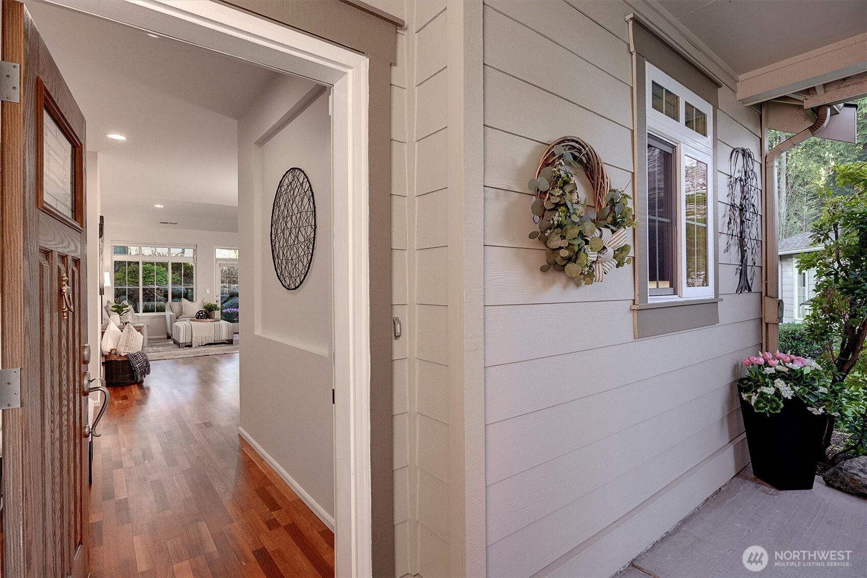 23857 Northeast 112th Circle, Unit 2 Redmond, WA 98053 - Photo 4 of 28 a view of a hallway with wooden floor and a potted plant