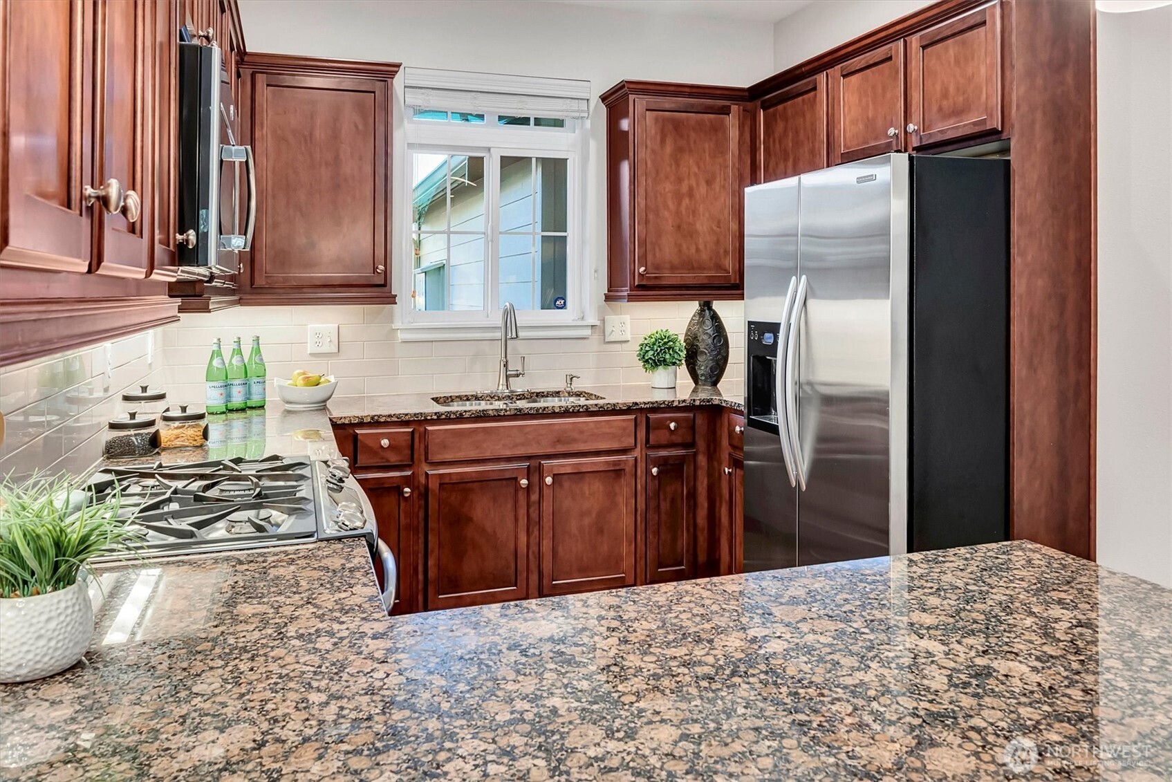 23857 Northeast 112th Circle, Unit 2 Redmond, WA 98053 - Photo 8 of 28 a kitchen with stainless steel appliances granite countertop a refrigerator a stove and a sink